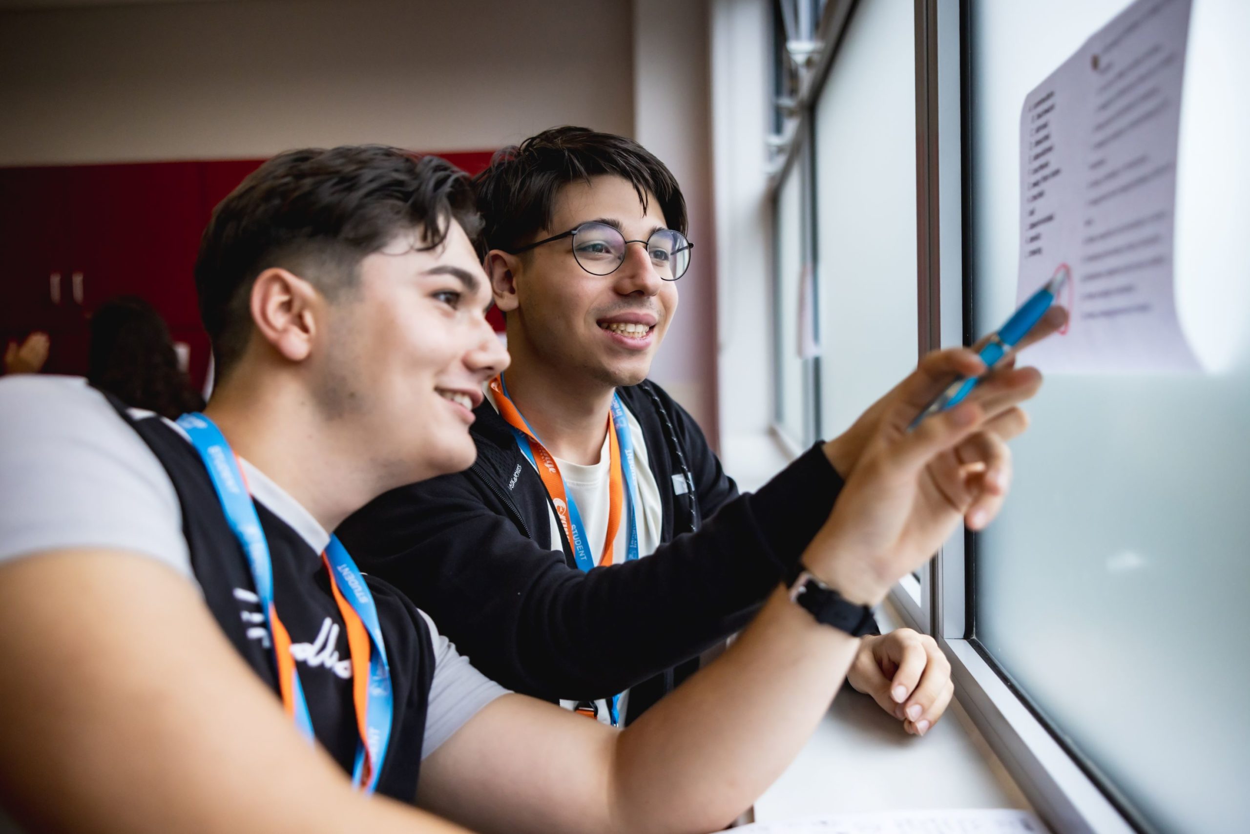 Boys reviewing a paper at Language in Action